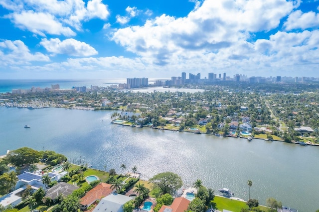 birds eye view of property featuring a water view and a city view