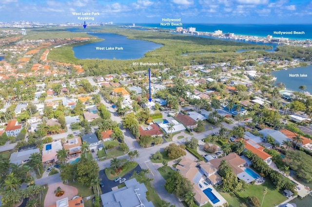 drone / aerial view featuring a water view and a residential view