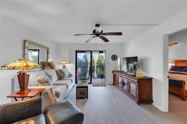 living area with light wood-type flooring and a ceiling fan