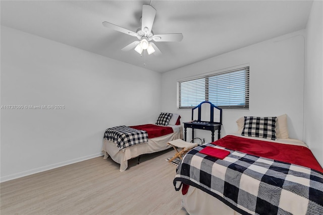 bedroom with wood finished floors, a ceiling fan, and baseboards