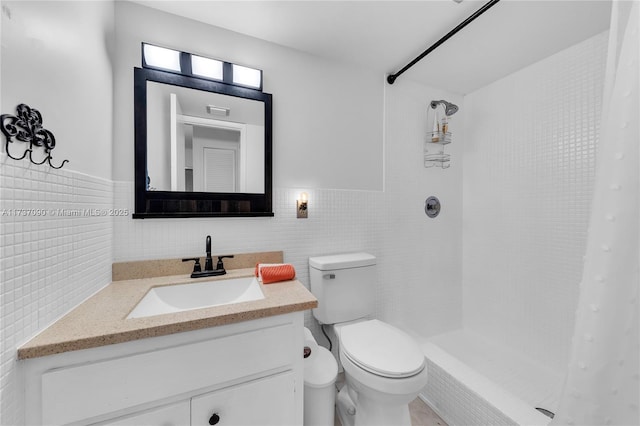 full bath featuring toilet, tile walls, tiled shower, and vanity