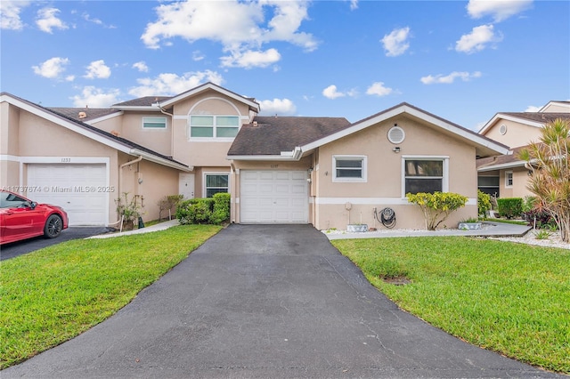 view of front of home with aphalt driveway, stucco siding, a shingled roof, an attached garage, and a front lawn