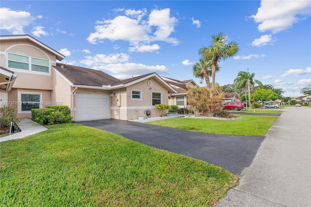 townhome / multi-family property with aphalt driveway, an attached garage, a residential view, stucco siding, and a front yard