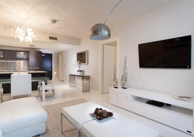 tiled living room with a notable chandelier