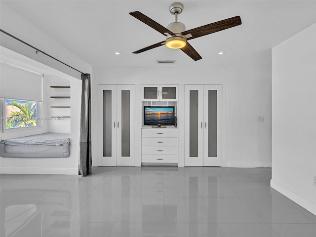 unfurnished living room with ceiling fan and light tile patterned flooring