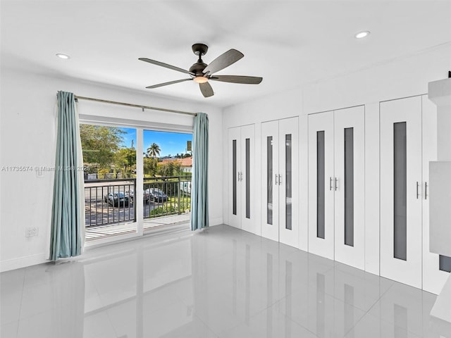 spare room with tile patterned floors and ceiling fan