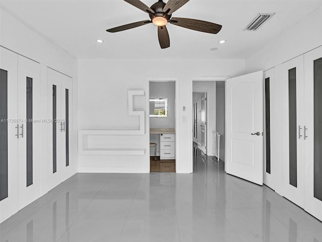 unfurnished bedroom featuring ceiling fan and dark tile patterned floors