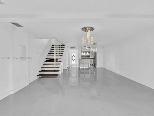 stairway with an inviting chandelier