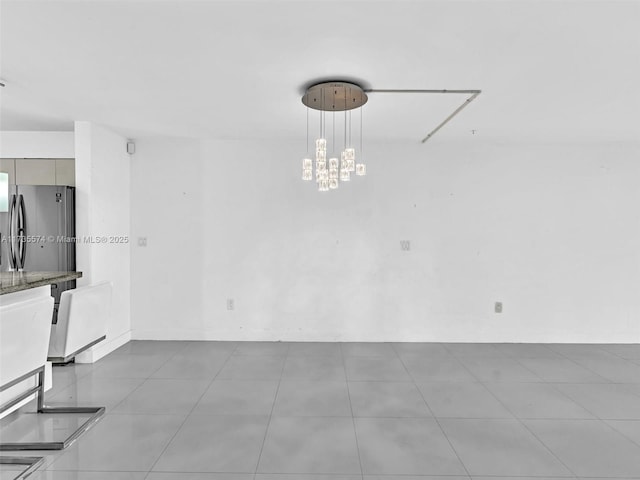 unfurnished dining area with an inviting chandelier