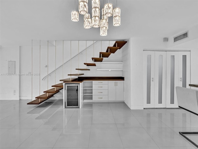 stairway featuring wine cooler