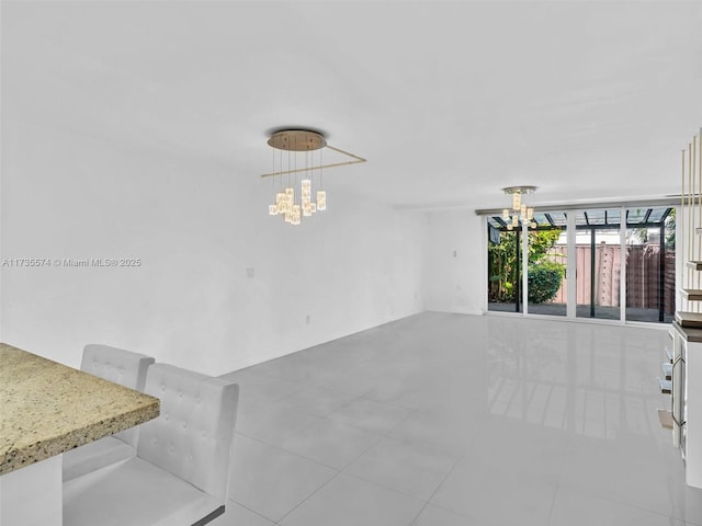 unfurnished living room with a chandelier