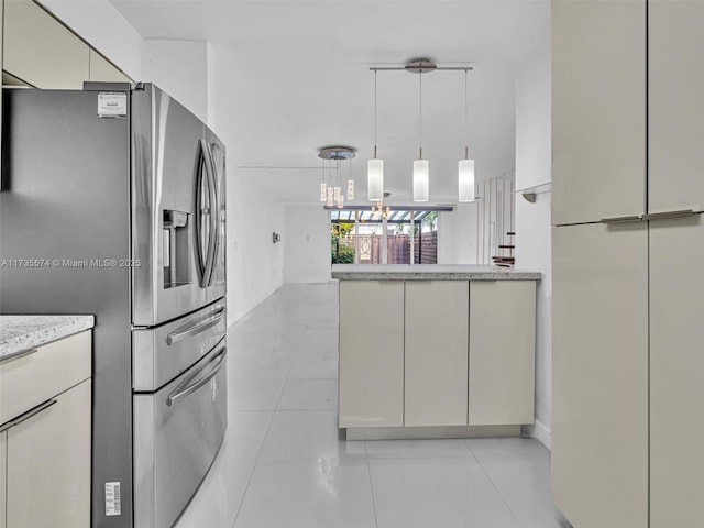 kitchen with light tile patterned floors, hanging light fixtures, light stone countertops, stainless steel fridge with ice dispenser, and cream cabinetry