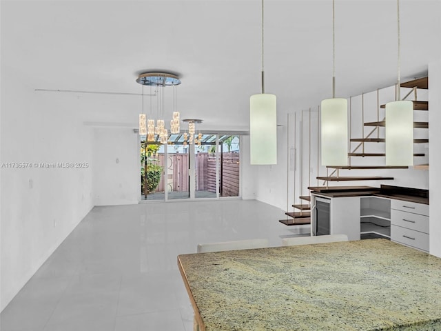 kitchen featuring white cabinetry, hanging light fixtures, and tile patterned flooring