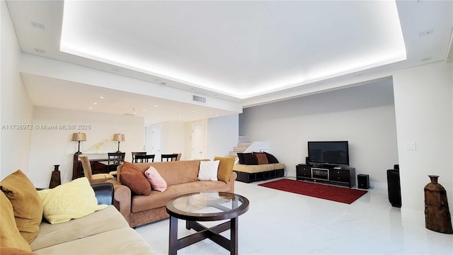 living room featuring a tray ceiling