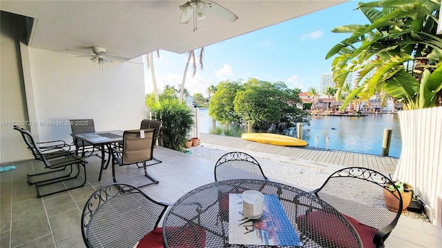 view of patio featuring a water view and ceiling fan