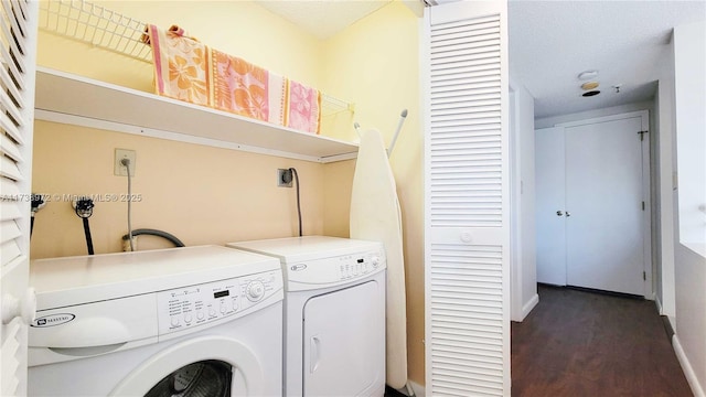 laundry room with dark wood-type flooring and washer and clothes dryer