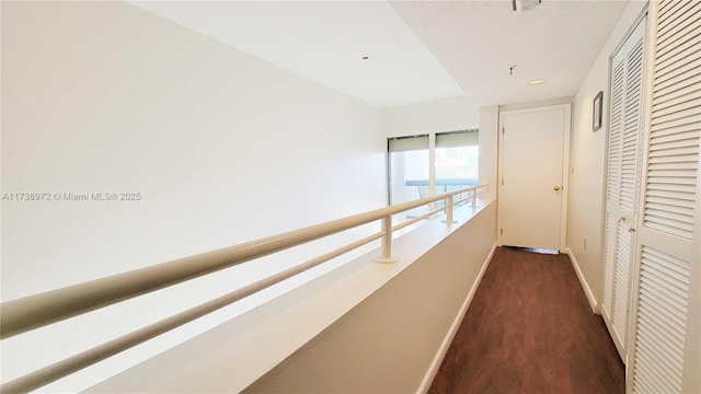 corridor with dark hardwood / wood-style flooring