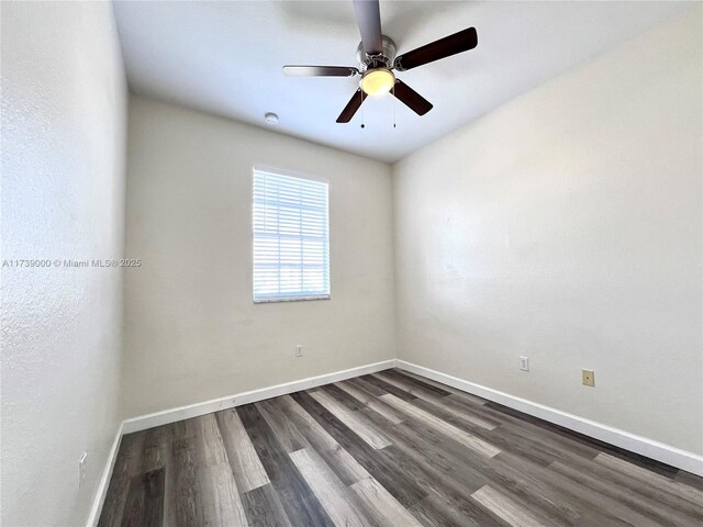 spare room with dark hardwood / wood-style floors and ceiling fan