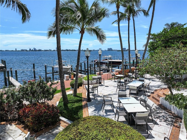 view of patio / terrace featuring a water view and a dock