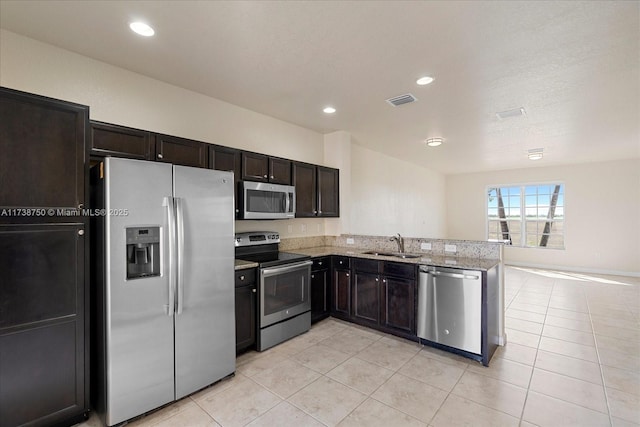 kitchen featuring light tile patterned floors, visible vents, stainless steel appliances, and a sink