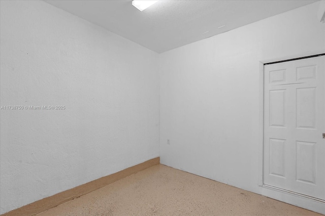 spare room with speckled floor