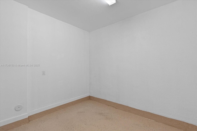 empty room featuring baseboards