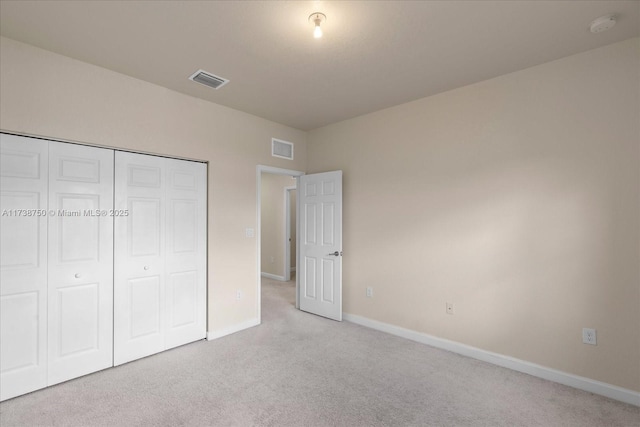 unfurnished bedroom with light colored carpet, visible vents, and baseboards