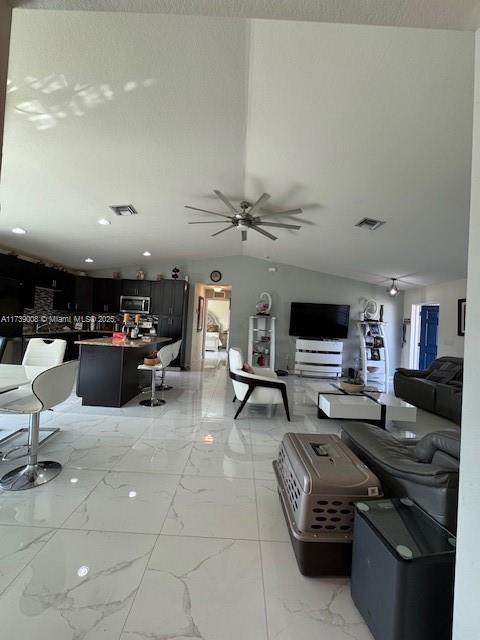 living room featuring lofted ceiling and ceiling fan