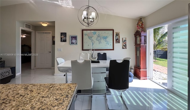 dining area with an inviting chandelier and vaulted ceiling