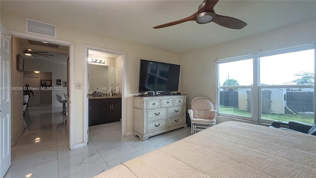 bedroom with ceiling fan and connected bathroom