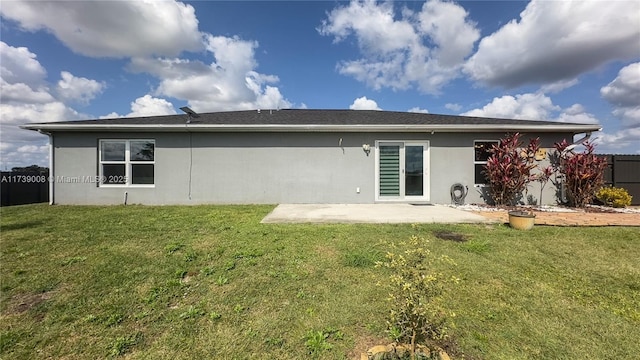 rear view of property with a patio area and a lawn