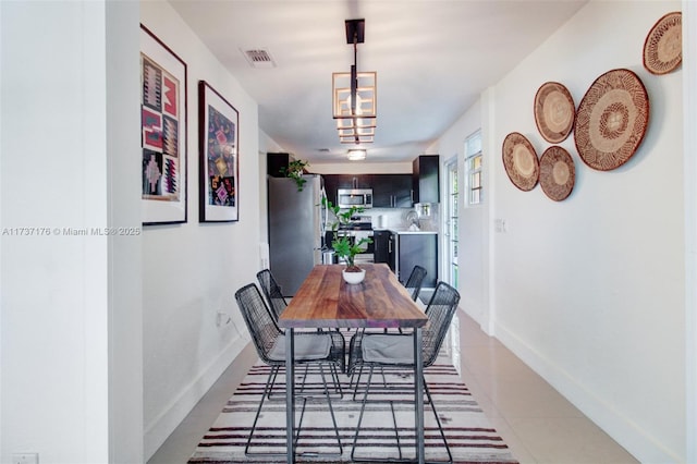 dining space featuring light tile patterned floors