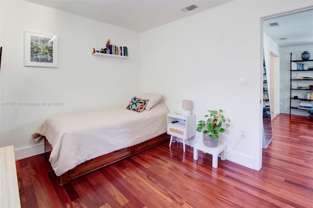 bedroom with hardwood / wood-style floors