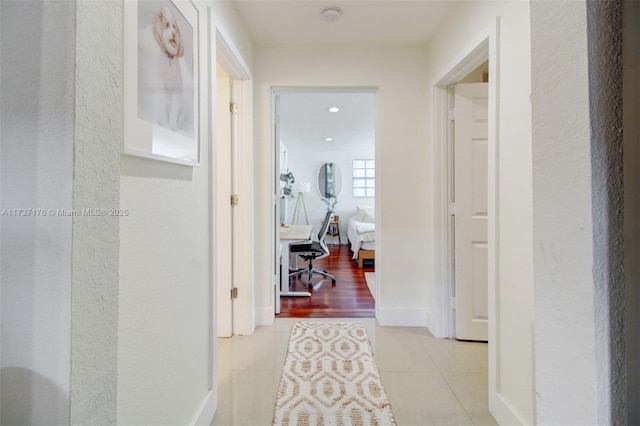 hall featuring light tile patterned flooring