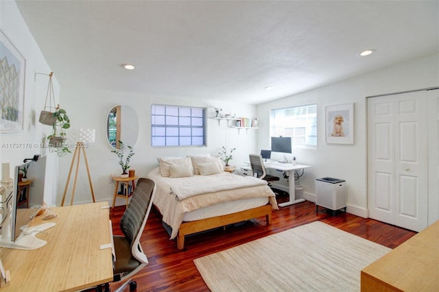 bedroom with dark hardwood / wood-style flooring and lofted ceiling