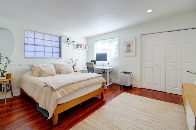 bedroom featuring dark hardwood / wood-style flooring and a closet