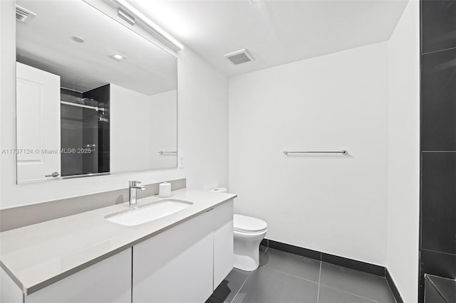 bathroom with vanity, an enclosed shower, tile patterned floors, and toilet