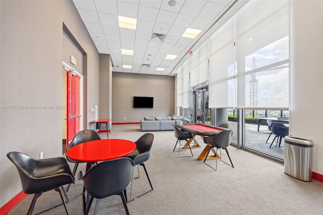 playroom featuring a high ceiling, carpet floors, and a drop ceiling