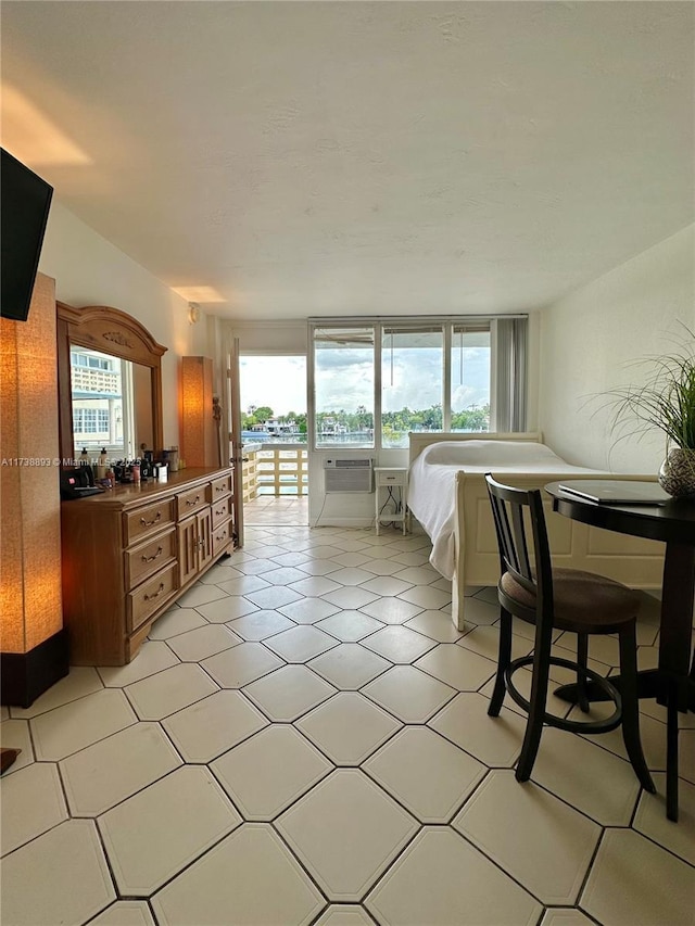 bedroom featuring light tile patterned floors and access to outside