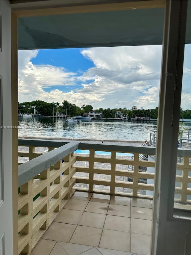 dock area with a balcony and a water view