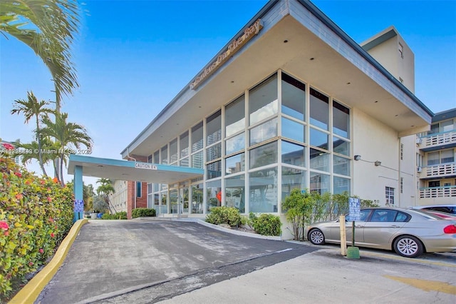 view of building exterior with uncovered parking