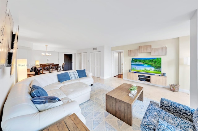 tiled living room with a chandelier