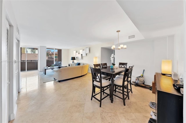 dining room featuring a wall of windows and a chandelier