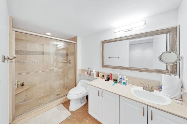 bathroom featuring vanity, toilet, and a shower with door