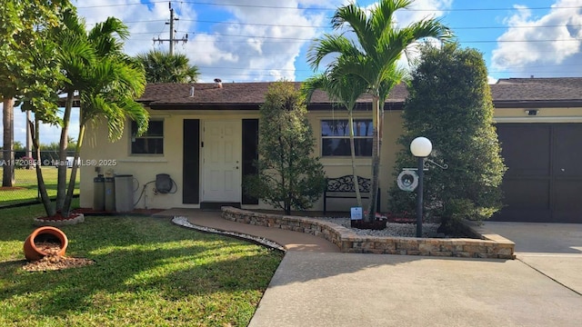 view of front of home with a garage and a front yard