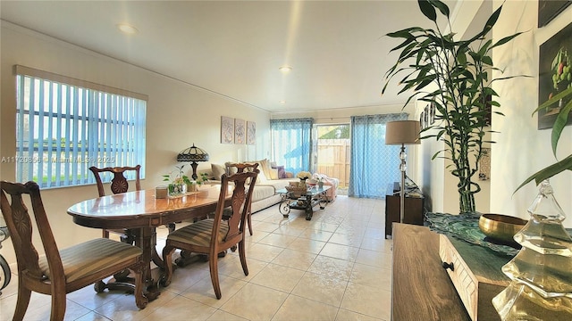 dining area featuring crown molding and light tile patterned floors