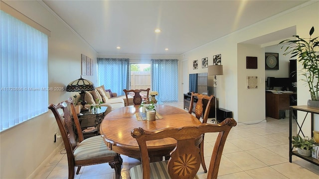 dining space featuring ornamental molding and light tile patterned floors