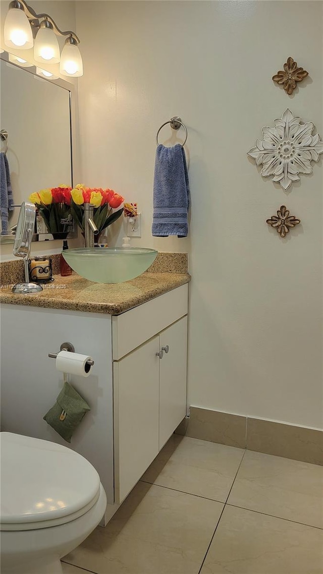 bathroom featuring tile patterned floors, vanity, and toilet