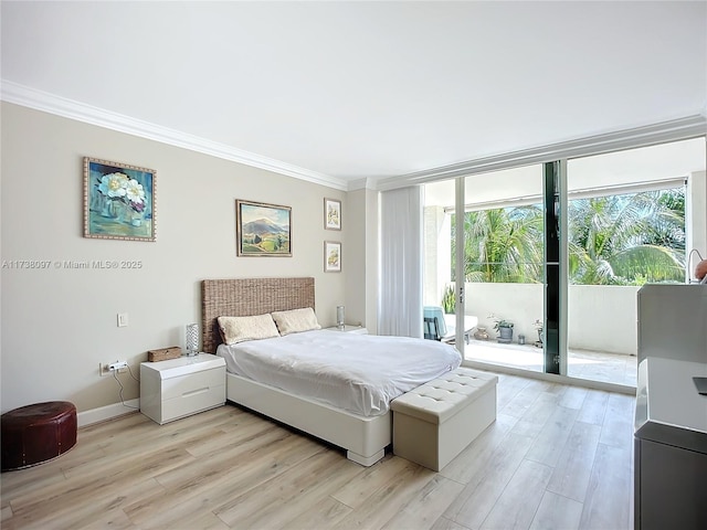 bedroom featuring crown molding, access to exterior, multiple windows, and light wood-type flooring