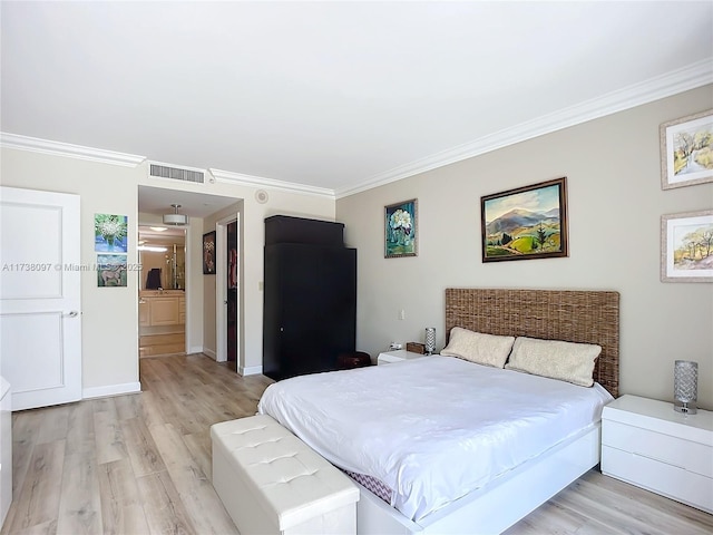 bedroom featuring crown molding and light hardwood / wood-style floors